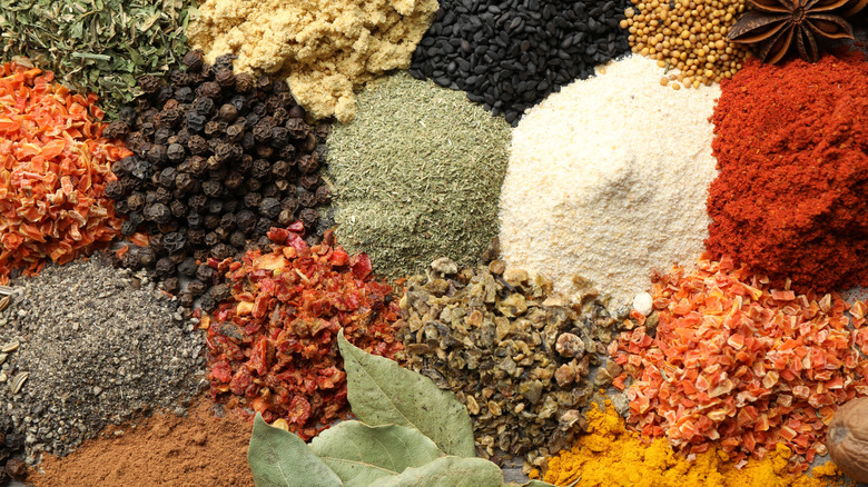 Piles of different spices together but separate.