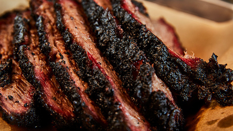 A close-up of sliced brisket with a dark bark