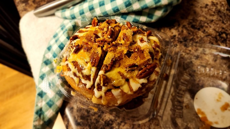 Cinnamon roll from River Nile Cafe in an open plastic container
