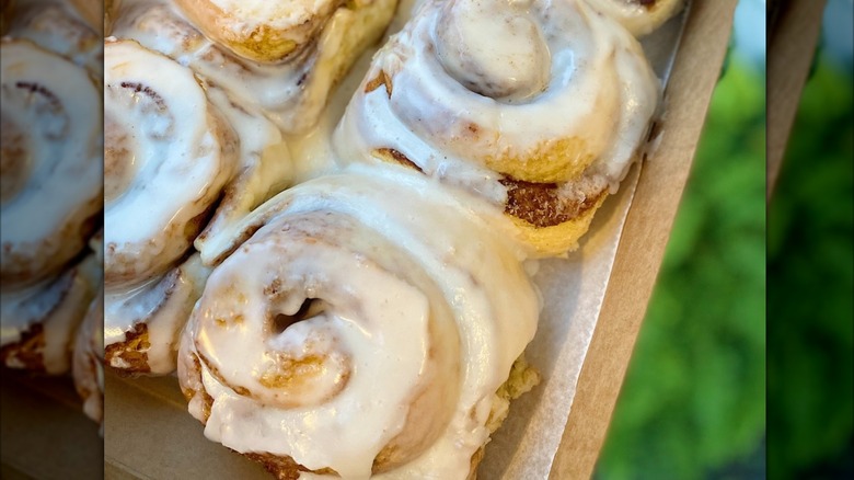 Box of multiple frosted Humble Crumb cinnamon rolls