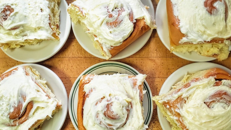 Six cinnamon rolls from Goldys Corner on plates
