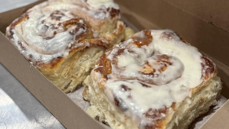 Two Sweet Cheeks Bakery cinnamon rolls in a takeaway box