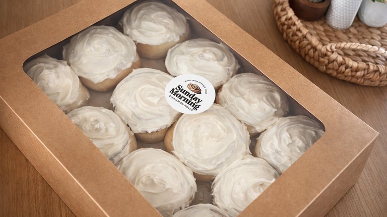 Frosted cinnamon rolls in a takeout box