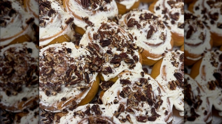 Frosted cinnamon rolls, topped with nuts