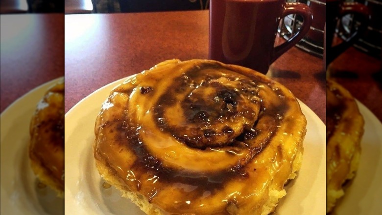 Cinnamon roll from Bakers Bakery next to mug