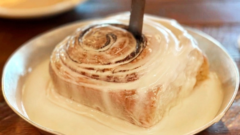 Cinnamon roll from Five Oak Farms with a knife in it
