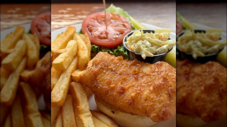 Close up of fried fish sandwich with side of fries and coleslaw at Nick's Fish House in Maryland