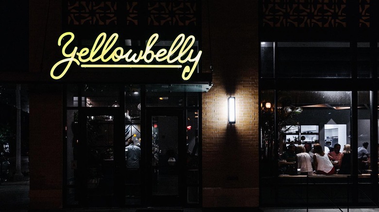 exterior of yellowbelly at night with sign lit up