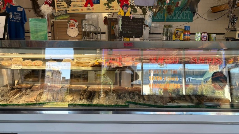 Seafood counter at Barbera's with fresh fish and seafood salads decorated for christmas