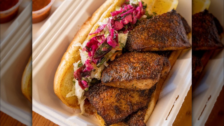 blackened fish sandwich with slaw in takeout container