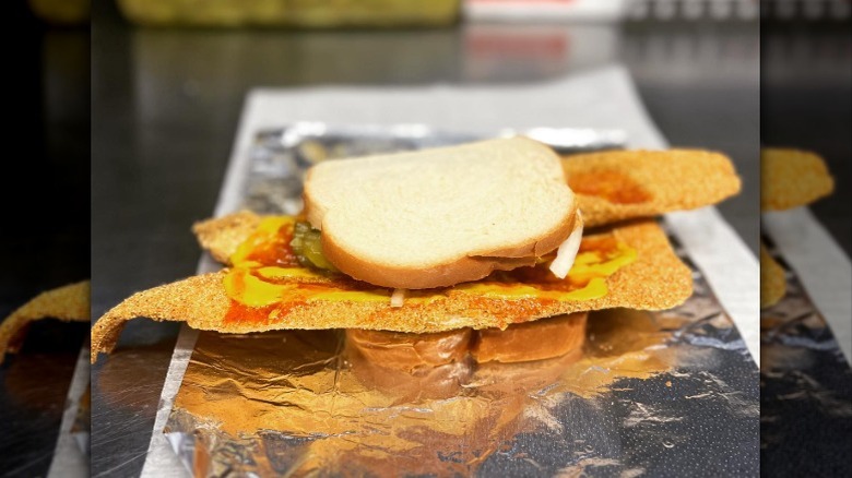large fish filet on sandwich on foil
