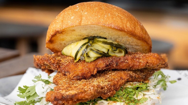 fish sandwich with pickles on top