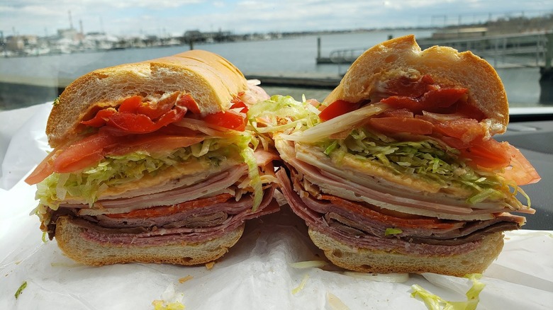 The Bomb sandwich sliced in half, with waterside in the background