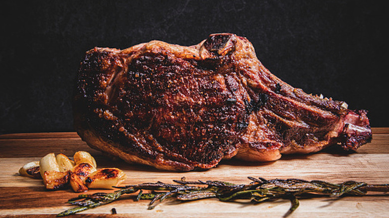 Cooked prime rib resting on a board
