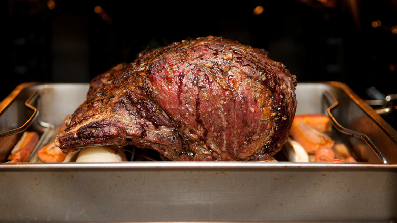 Prime rib in a roasting pan in the oven