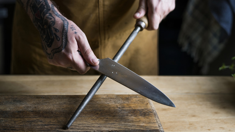 Chef or home cook sharpening a knife