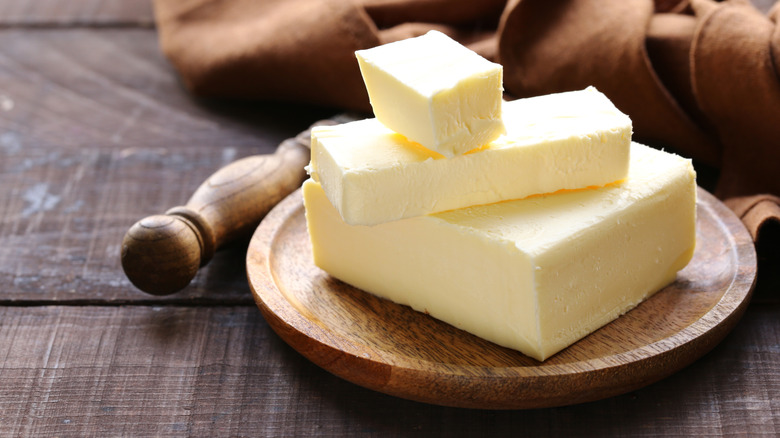Slabs of butter on a wooden plate