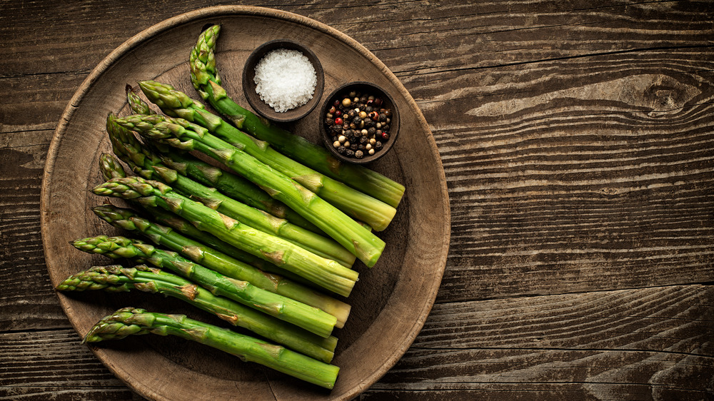 Fresh asparagus in wooden bowl