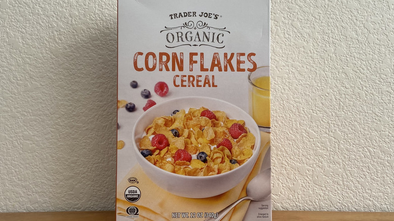A box of Trader Joe's organic corn flakes cereal against a white wall