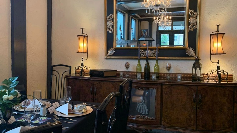 Table and interior decor of Sinatra's Ristorante, with mirror and antiques