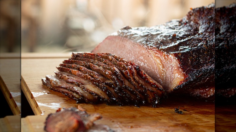 Juicy barbecue brisket sliced on cutting board