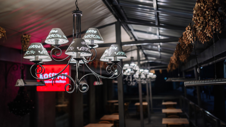 hanging chandeliers in dimly lit outdoor dining area