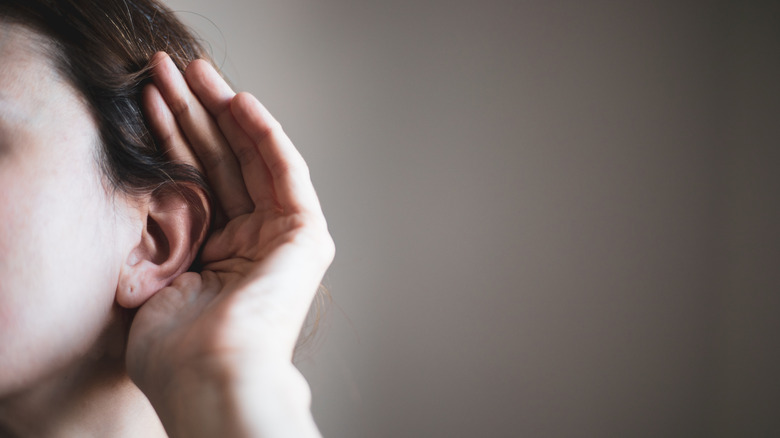 woman trying to eavesdrop