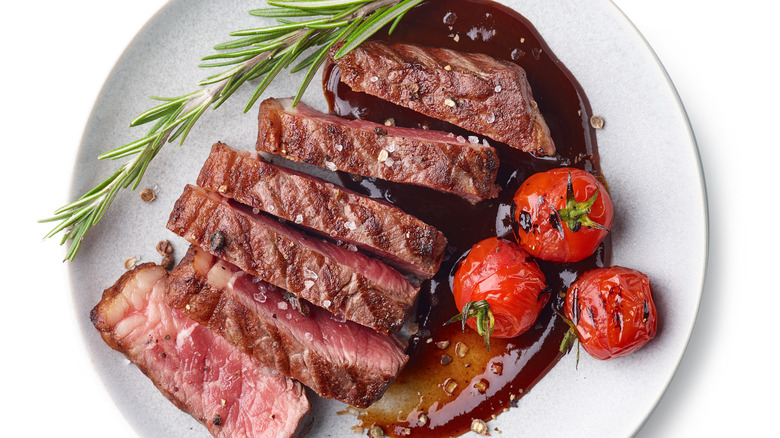 Sliced steak and roasted tomatoes