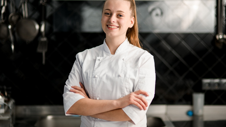 Chef in kitchen smiling 