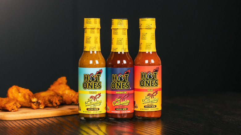 Three "Hot Ones" sauce bottles