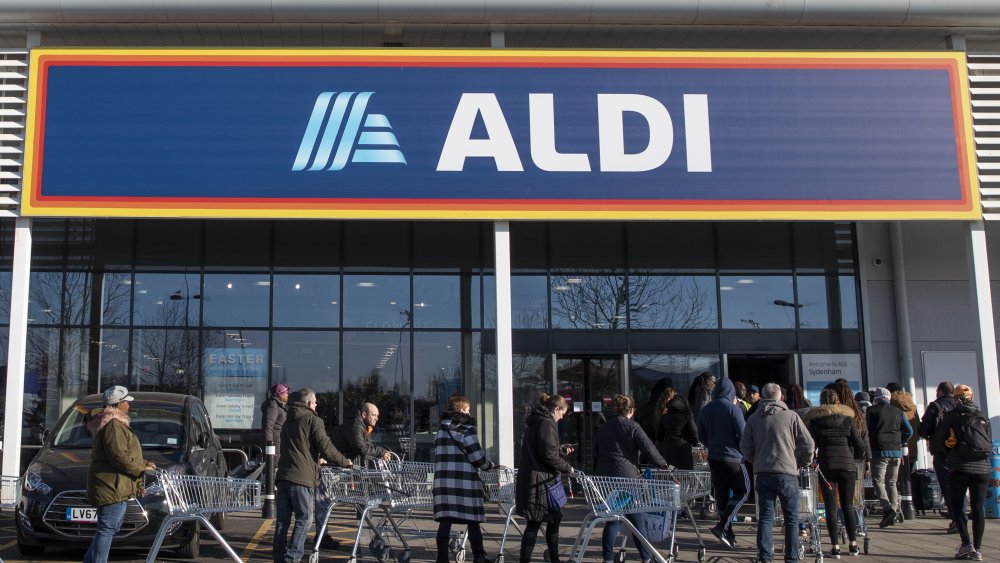 Shoppers waiting in front of an Aldi store