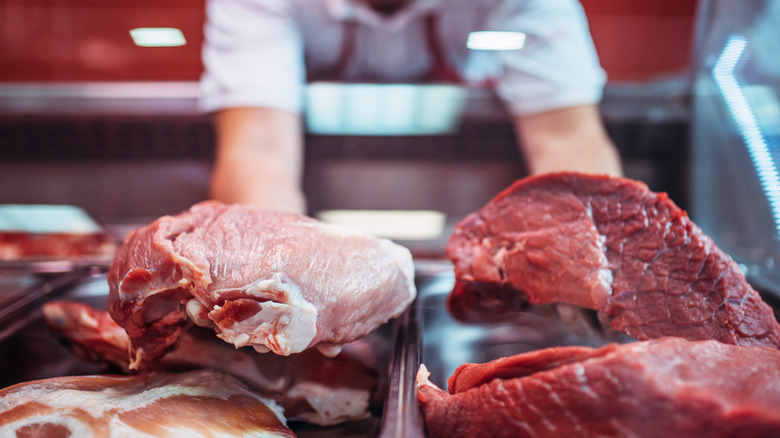 Worker handles slabs of meat