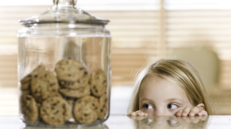 cookies in jar with child looking at them 