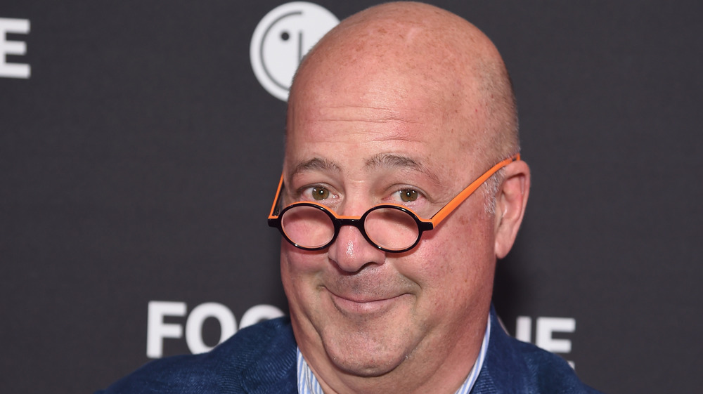 Andrew Zimmern in black and orange glasses