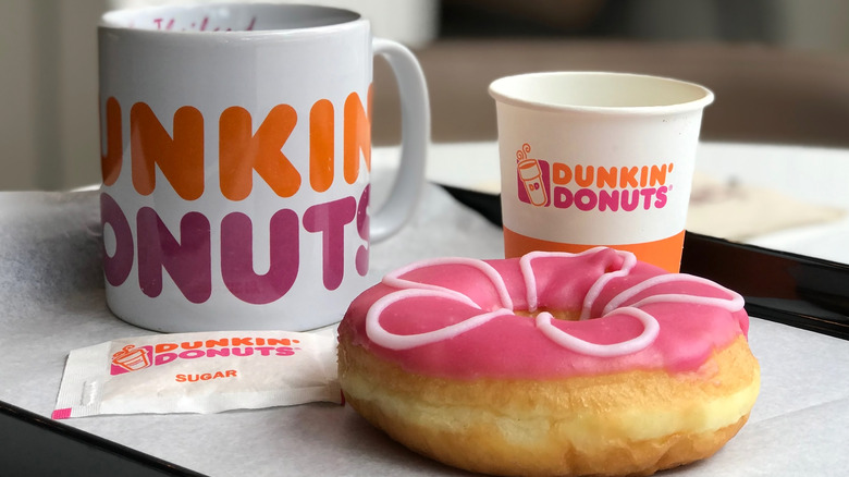 Dunkin' coffee and pink iced donut