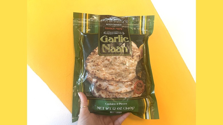 A package of Trader Joe's garlic naan on a yellow and white background
