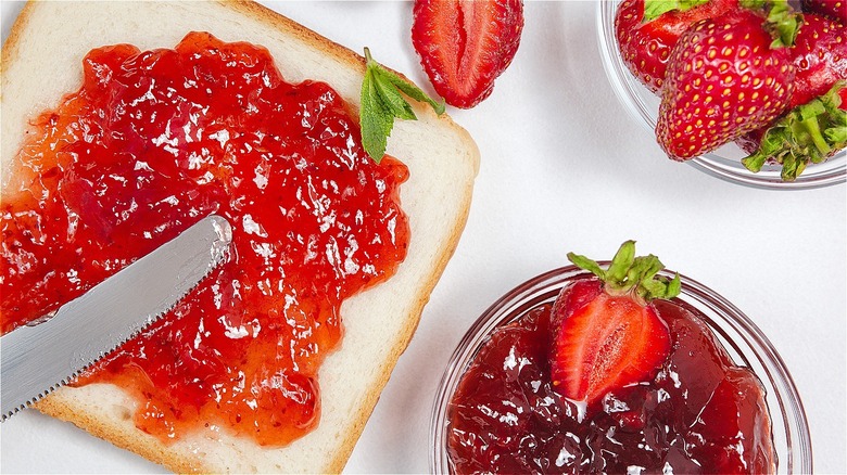 Person making homemade strawberry jam