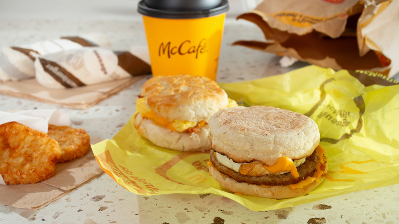 McDonald's breakfast sandwiches on table with hashbrowns and coffee