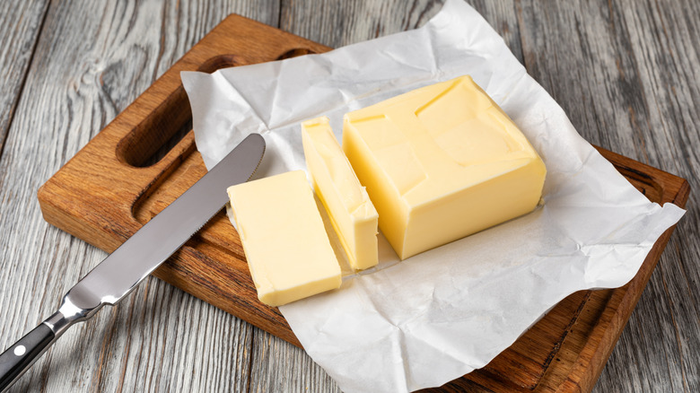 Block of butter on cutting board with knife
