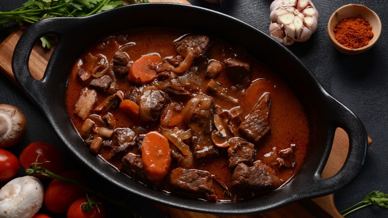 Meat and vegetables braising in a black pot