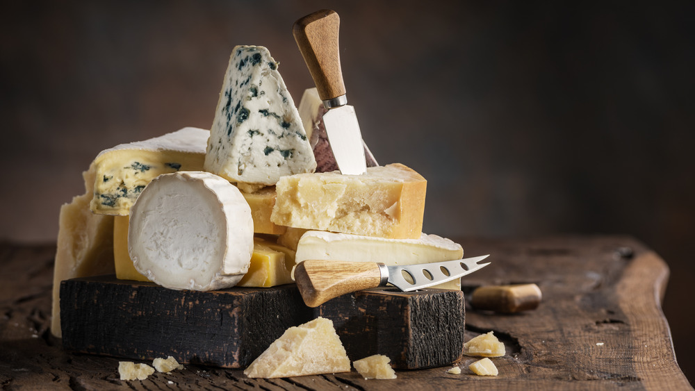Assorted cheeses on wooden block