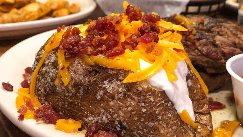 Closeup of Texas Roadhouse loaded baked potato.
