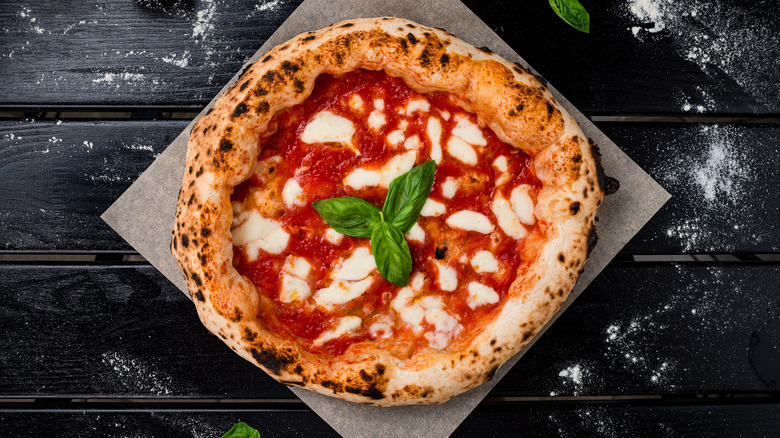 homemade pizza pie with fresh basil and mozzarella 