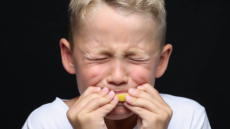 Kid eating sour food