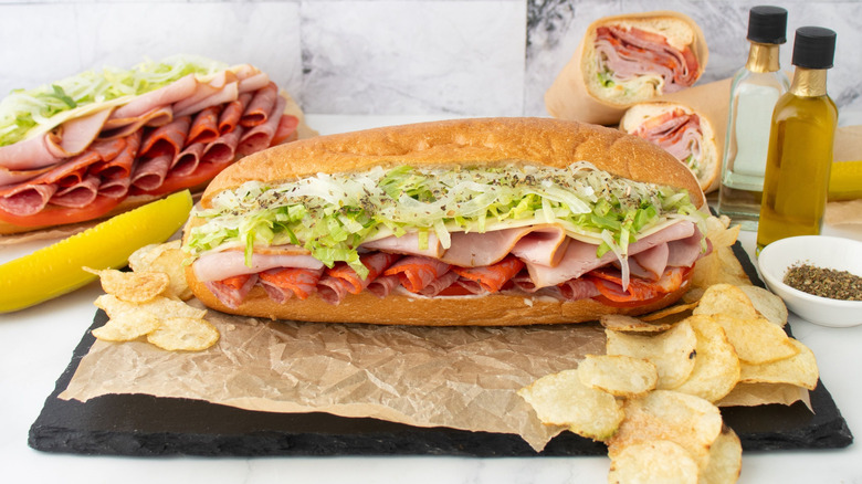 Italian Night Club sandwiches next to pickles and chips