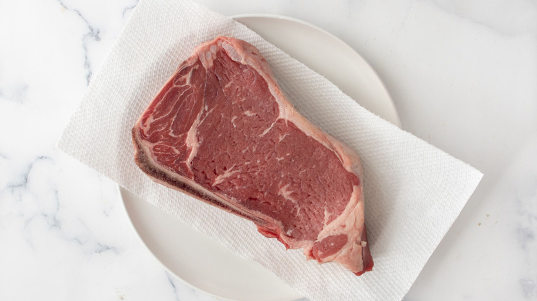 Raw steak on paper towels