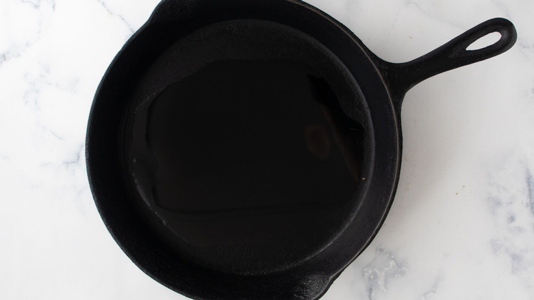 Cast iron skillet with oil in it