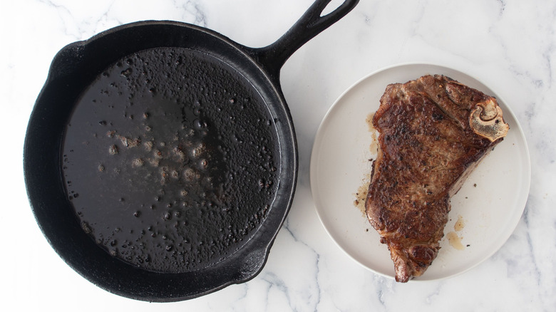 Cast iron skillet and steak on plate