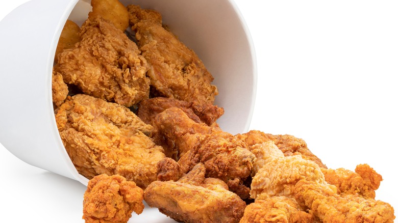 Fried chicken falling out of bucket