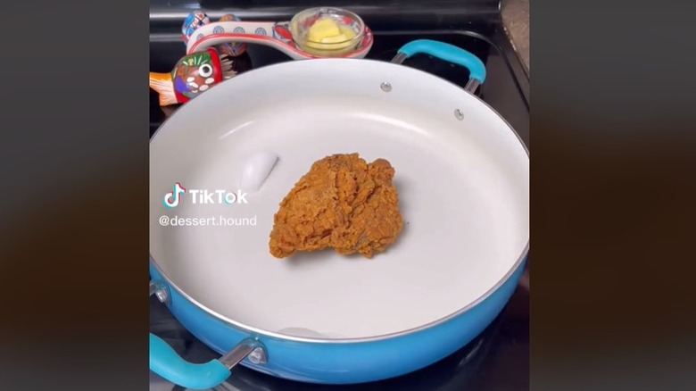 Fried chicken in a pan with ice cubes